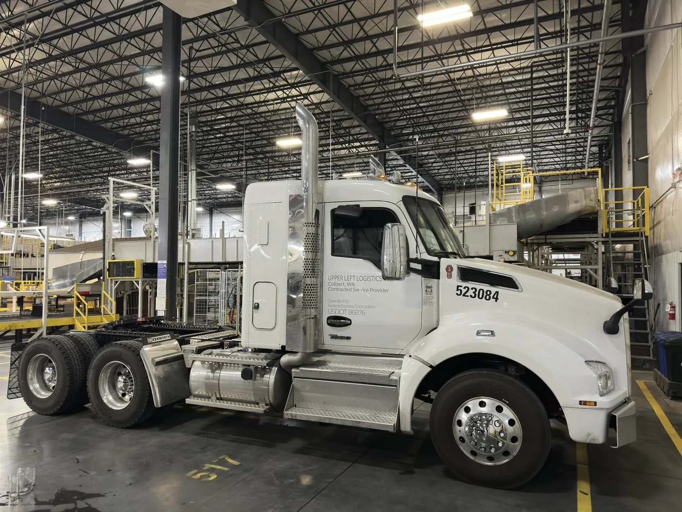 An Upper Left Logistics tractor staged inside a distribution facility